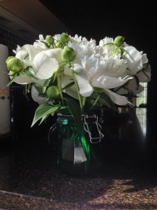 I didn't have a short vase, so I put the peonies in this glass canister and loved the effect.